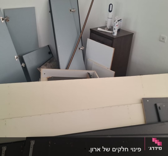חלקי ארונות ורהיטים מפורקים בדירה במהלך תהליך פינוי